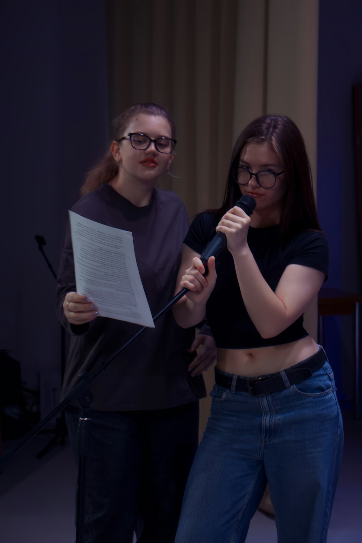 Two women performing karaoke together