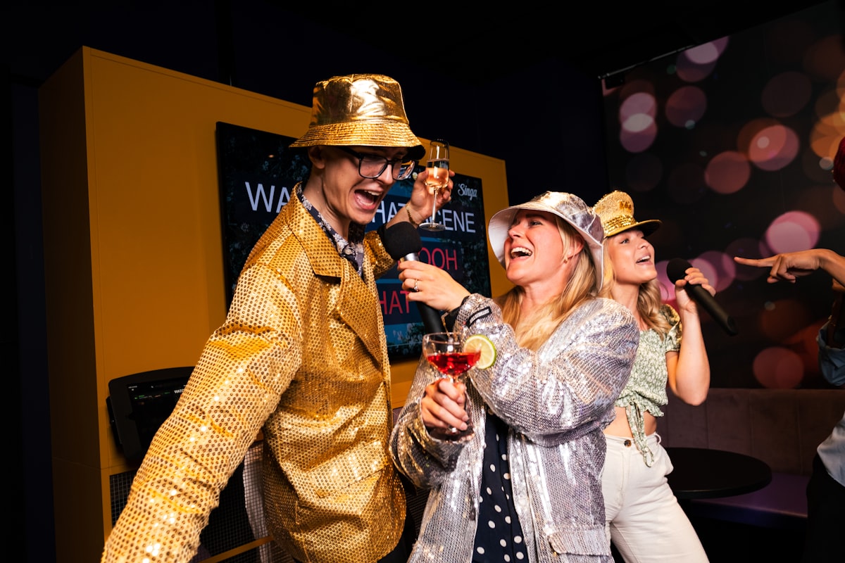 People partying and singing karaoke with microphones